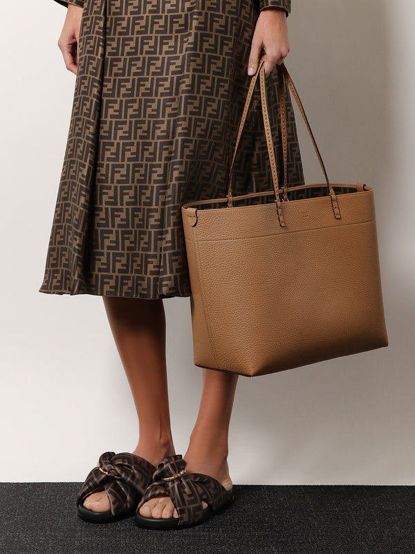 Roll leather shoulder bag with engraved logo on the front